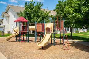Eagan townhouse for rent - a playground with two slides and a swing set