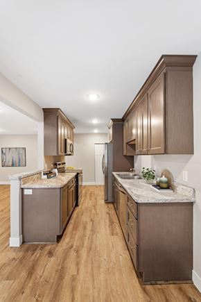 Chanhassen apartment for rent - A kitchen with brown cabinets and a marble countertop.