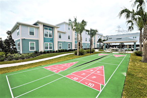 Spring Hill apartment for rent - a basketball court in front of a row of houses