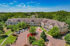 Oakdale apartment for rent - A large building with a parking lot in front of it.