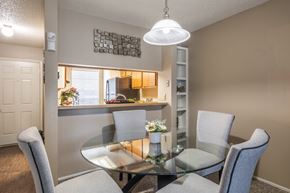 San Antonio apartment for rent - A dining room with a glass table and grey chairs.