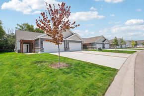 Monticello triplex for rent - a house with a driveway and a tree in front of it