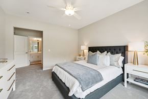 Monticello triplex for rent - a bedroom with a bed and a ceiling fan