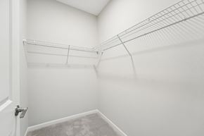 Monticello triplex for rent - a spacious closet in a home with white walls and a white door