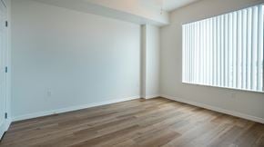 Lake Worth Beach apartment for rent - A room with wooden flooring and a window with blinds.