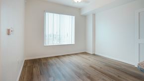 Lake Worth Beach apartment for rent - A room with a window and wooden flooring.