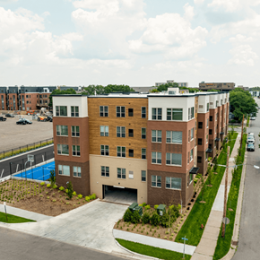 Hopkins apartment for rent - A modern apartment building with a pool in the backyard.