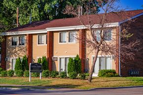 Golden Valley townhouse for rent - a brick building with a sign in front of it