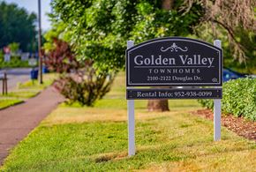 Golden Valley townhouse for rent - a sign for golden valley townhomes on the side of a sidewalk