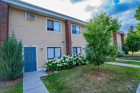 Golden Valley townhouse for rent - a side view of a house with a blue door