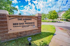 Oakdale apartment for rent - The Arbors at Red Oak Preserve sign in front of a tree.