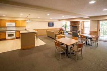 Oakdale apartment for rent - A spacious kitchen and dining area with a television mounted above the fireplace.