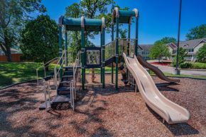 Oakdale apartment for rent - A playground with a slide and a climbing frame.