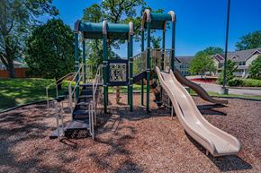 Oakdale apartment for rent - A playground with a slide and a climbing frame.