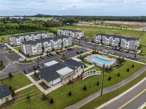 Ocala apartment for rent - A large apartment complex with a swimming pool and a playground.