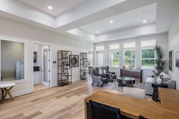 Ocala apartment for rent - A modern living room with a wooden floor and furniture.