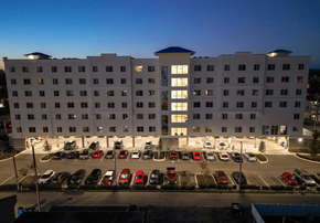 Cape Coral apartment for rent - A hotel parking lot is full of cars.