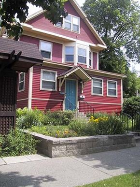 Minneapolis triplex for rent - A red house with a blue door and windows.
