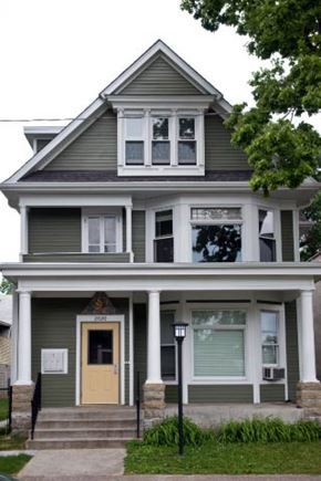 Minneapolis triplex for rent - A two story house with a front porch and a yellow door.