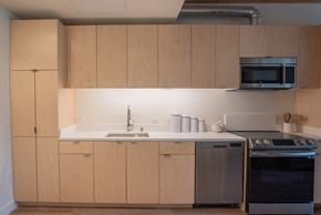 Oakland apartment for rent - a kitchen with wooden cabinets and a sink and a stove