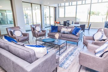 New Orleans apartment for rent - A living room with grey couches and blue pillows.