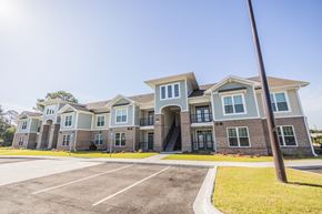 Tifton apartment for rent - an apartment building with an empty parking lot