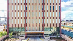 New Orleans apartment for rent - the facade of a building with a bench in front of it
