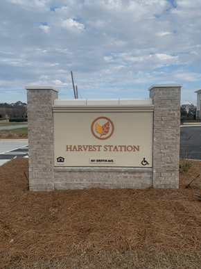 Valdosta apartment for rent - A sign for Harvest Station stands in front of a field.