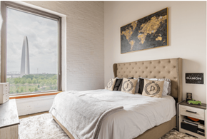 St. Louis apartment for rent - a bedroom with a large window and a bed with pillows