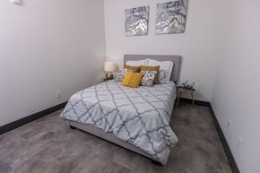 St. Louis apartment for rent - a bedroom with a bed and two paintings on the wall