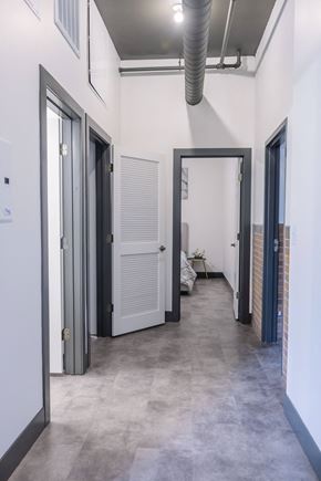St. Louis apartment for rent - a hallway with doors in a building with white walls and concrete floors