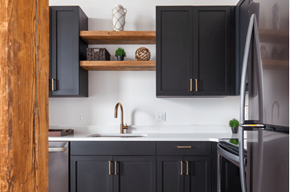 St. Louis apartment for rent - a kitchen with black cabinets and stainless steel appliances and wooden shelves
