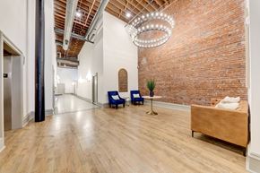 St. Louis apartment for rent - A room with a brick wall and a wooden floor.