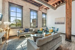 St. Louis apartment for rent - a living room with couches and chairs and large windows