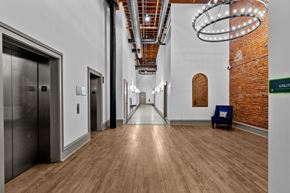 St. Louis apartment for rent - A hallway with a brick wall and a bench.