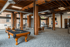 St. Louis apartment for rent - a room with a pool table in the center of it