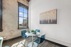 St. Louis apartment for rent - a dining area with a table and chairs and a large window