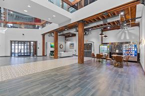 St. Louis apartment for rent - A spacious room with wooden floors and a high ceiling with a skylight.