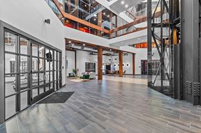 St. Louis apartment for rent - A modern interior with a long hallway and a staircase.