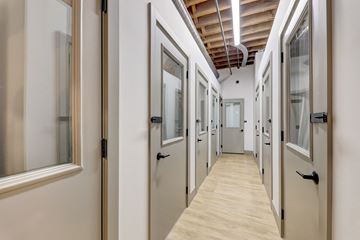 St. Louis apartment for rent - a hallway filled with doors and windows in a building
