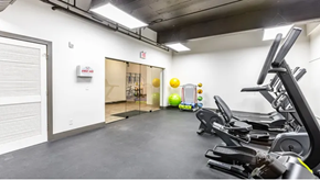 St. Louis apartment for rent - a gym with cardio equipment and a yellow ball in the background