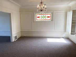 San Francisco apartment for rent - a dining room with a chandelier and a stained glass window