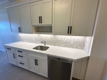 San Francisco apartment for rent - a small kitchen with white cabinets and a sink