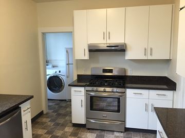 San Francisco apartment for rent - a kitchen with white cabinets and stainless steel appliances