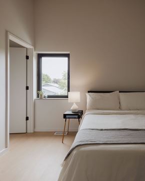 Saint Paul apartment for rent - A bedroom with a bed, nightstand, and window.
