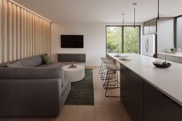 Saint Paul apartment for rent - A modern living room with a grey sofa and a television on the wall.