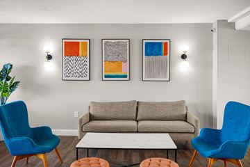 Brook Park apartment for rent - a living room with a couch and chairs and paintings on the wall