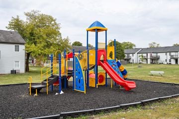 Columbus apartment for rent - A playground with a red slide and a blue and yellow structure.