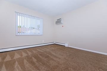 Eastlake apartment for rent - a spacious living room with carpet and a window