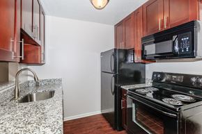 Eastlake apartment for rent - a kitchen with black appliances and granite countertops